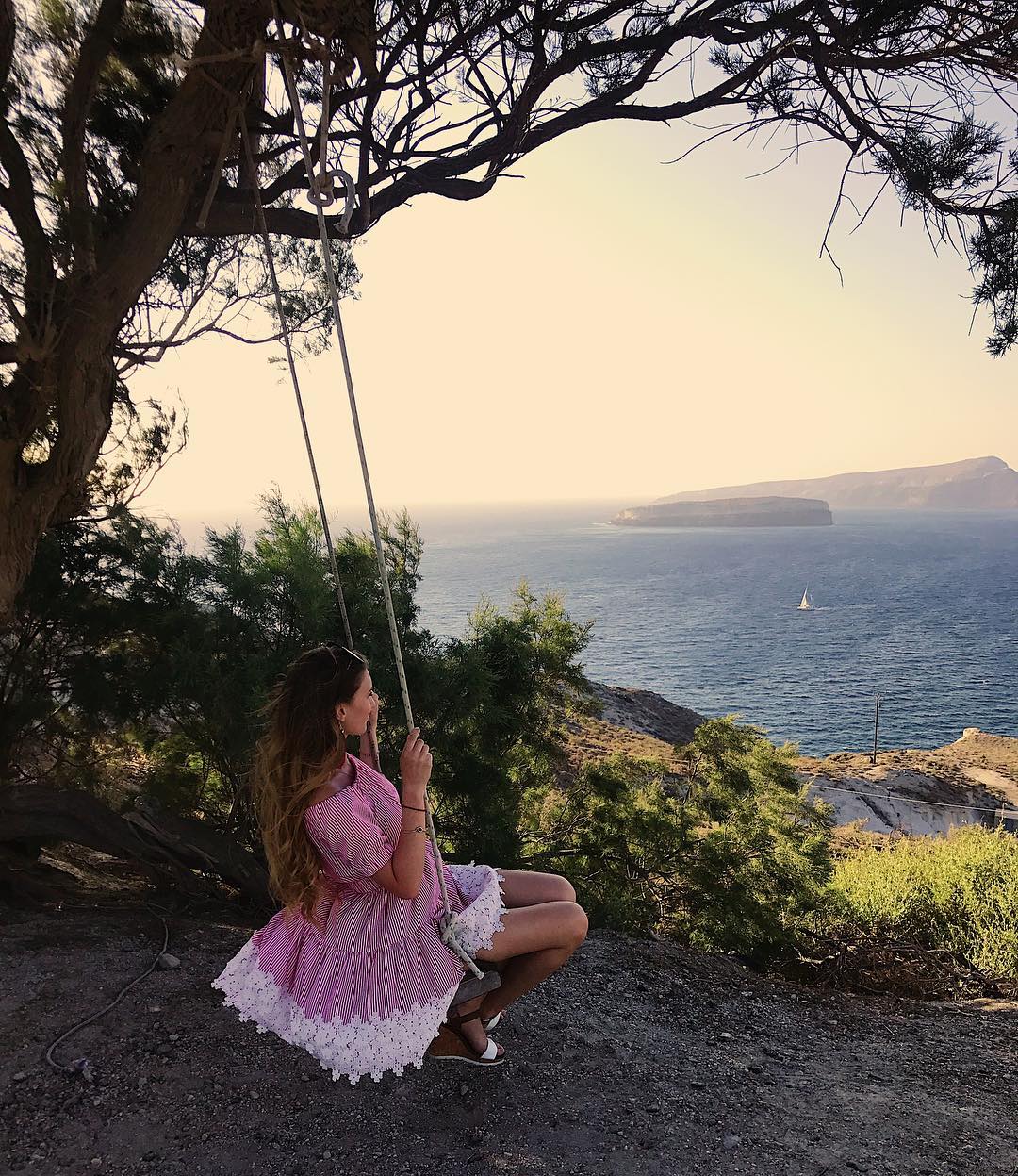 Akrotiri swing overlooking the water in Santorini 